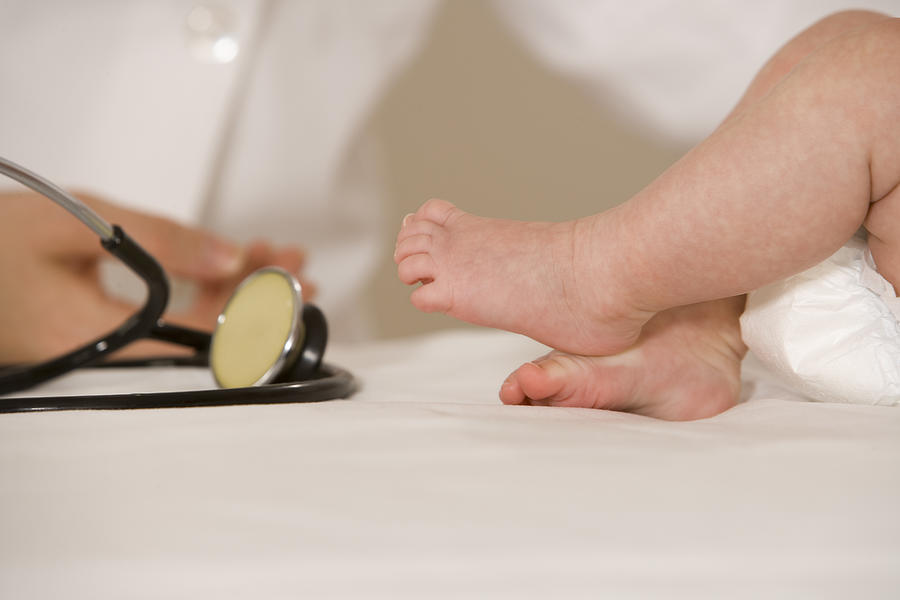 Babys feet and stethoscope Photograph by Comstock Images