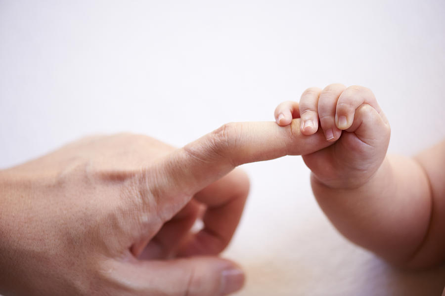 Babys Small Hand Holding Fathers Finger Photograph by Jaunty Junto