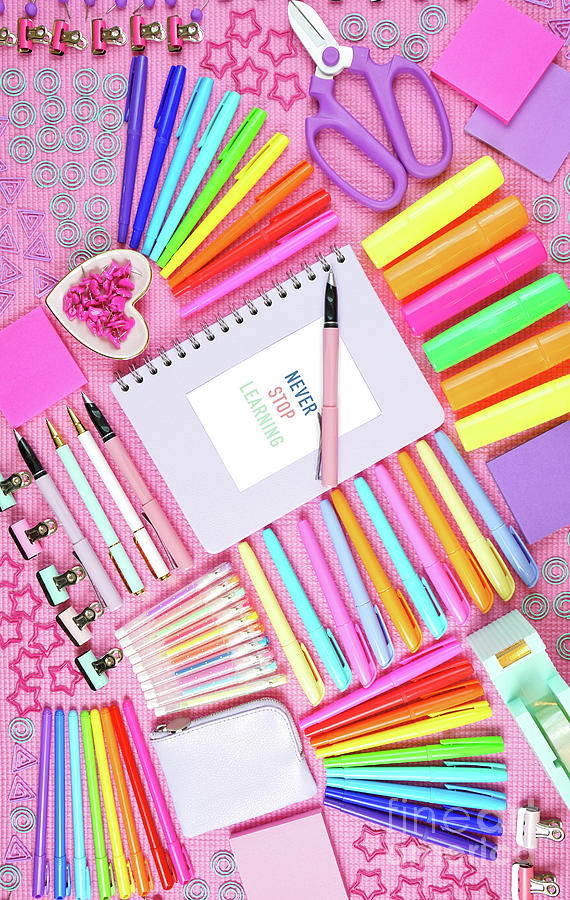 Inspirational Photograph - Back to school or workspace colorful stationery overhead on pink background. by Milleflore Images