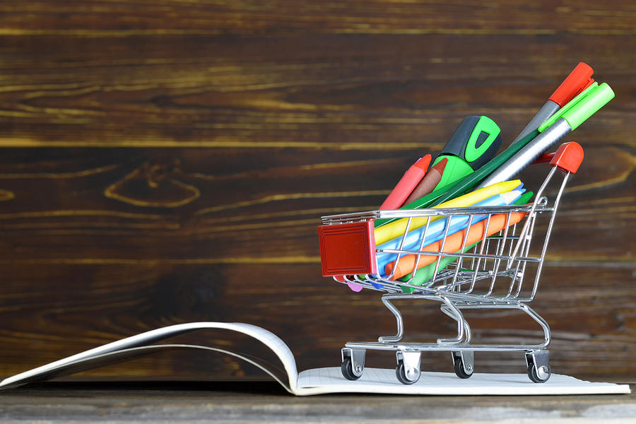 Back to school. School supplies in shopping cart Photograph by Izzzy71