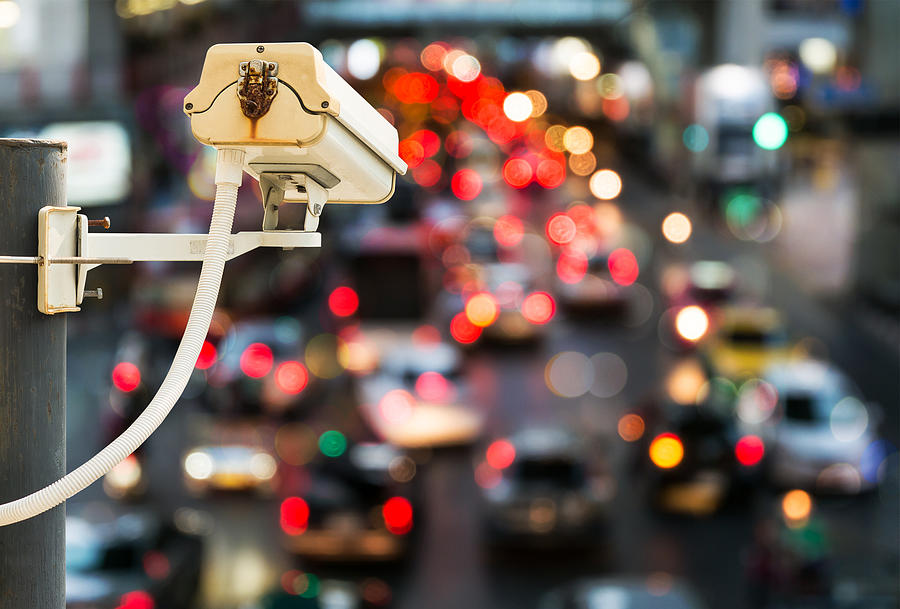 Back view of CCTV Camera with traffic jam light bokeh Photograph by NIpitphand