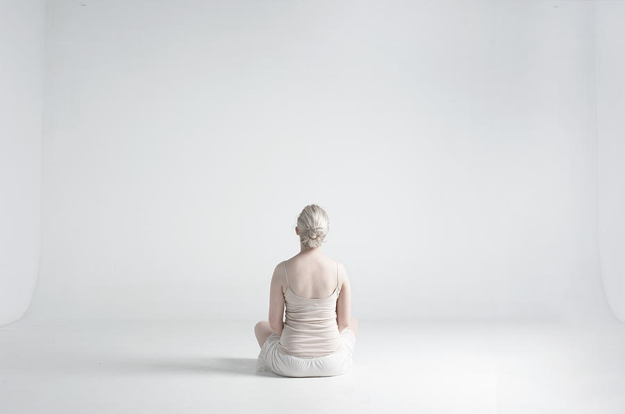 Back Woman Sitting Cross Legged In White Studio Photograph by Tara Moore