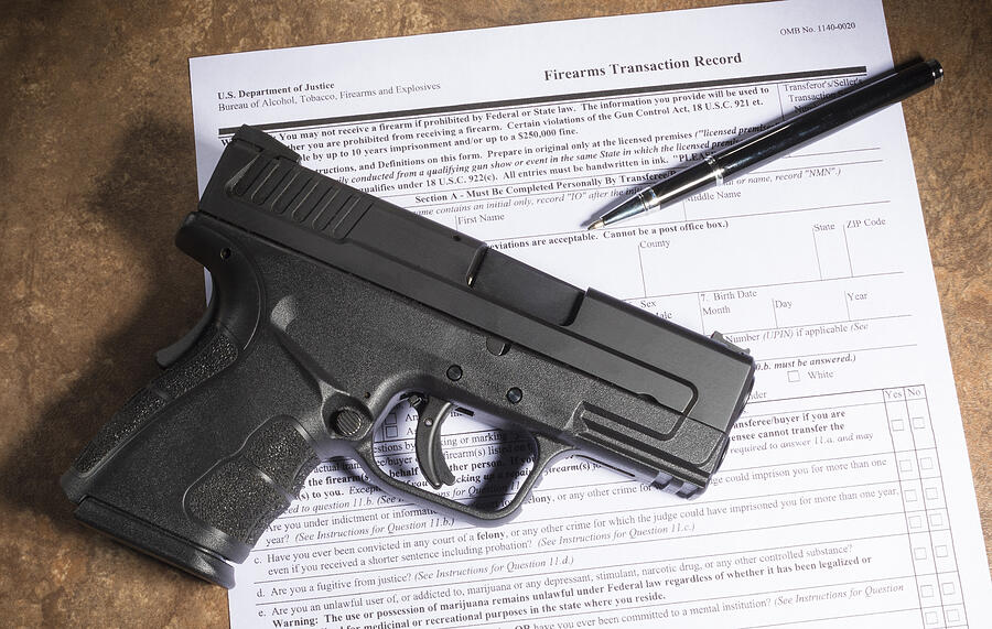 Background check for a gun purchase with a handgun Photograph by Gsagi