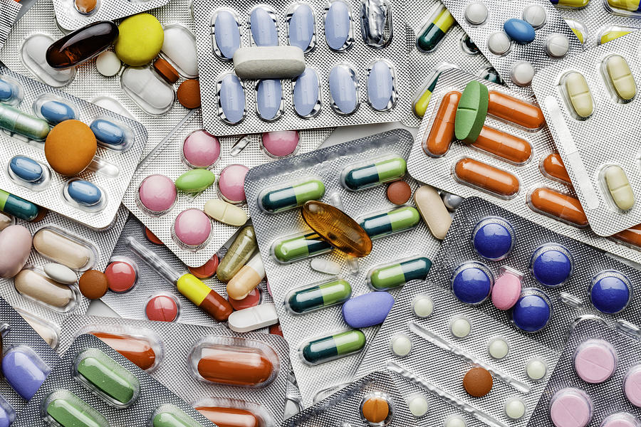 Background of a large group of assorted capsules, pills and blisters Photograph by Apomares