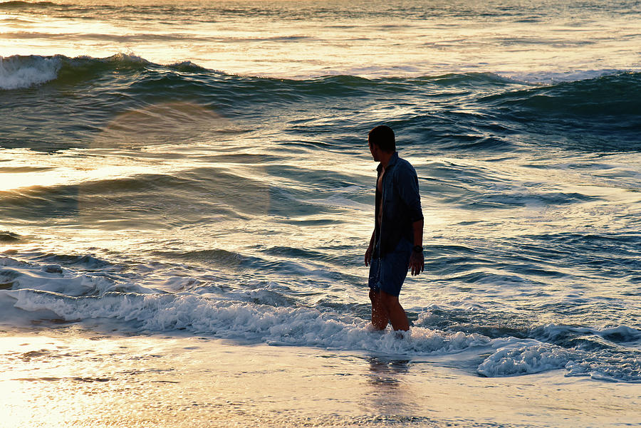 Backlit handsome man in the ocean during a beautiful sunset Photograph by Mark Stout