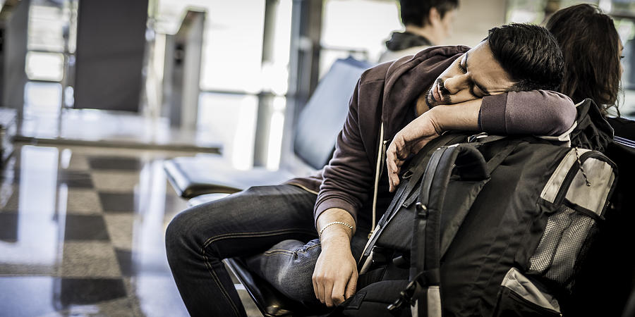 Backpacker napping while waiting for the airplane Photograph by Vm