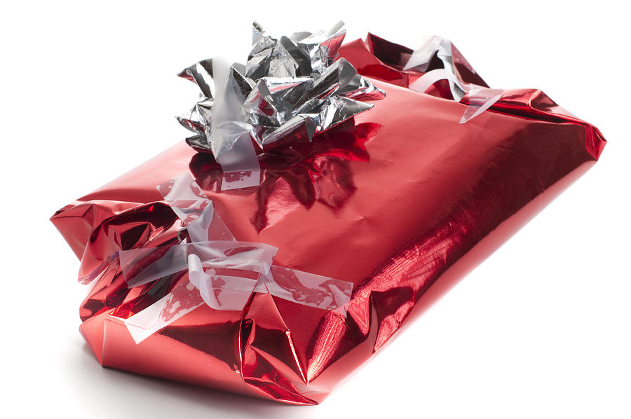 Badly wrapped, messy Christmas present Photograph by R_Koopmans