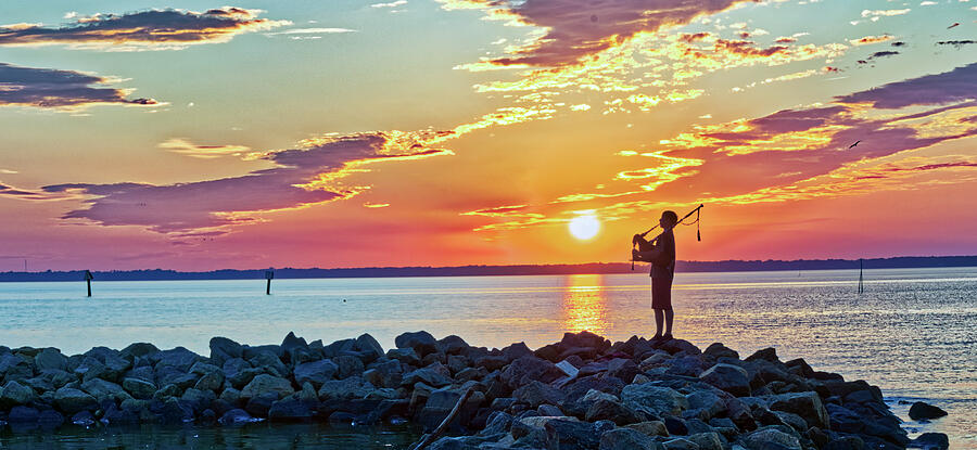 Bagpiper on Jetty Photograph by Jerry Gammon