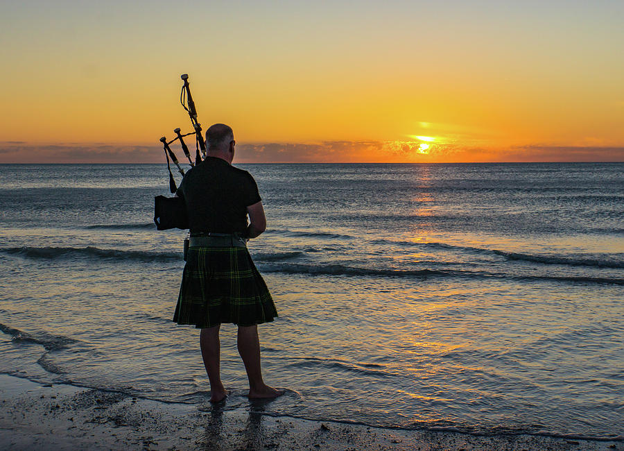Bagpipes at sunset on the Beach Photograph by Ann Moore