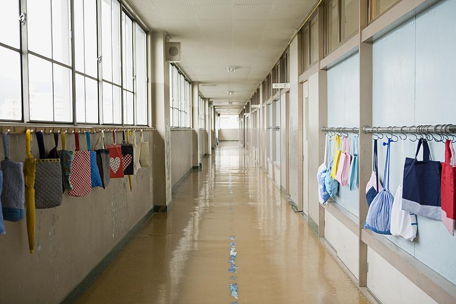 Bags hanging in a corridor Photograph by Image Source