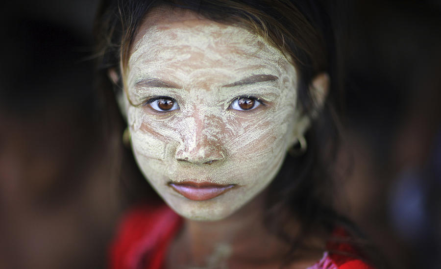Bajau sea gypsy girl with face mask on houseboat Photograph by Timothy Allen