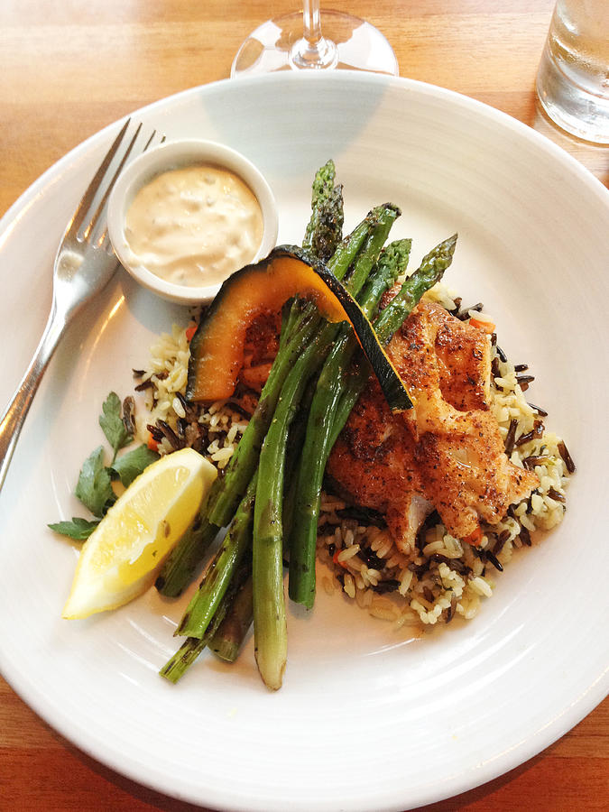 Baked Halibut on wild rice with asparagus and acorn squash Photograph by Bill Boch