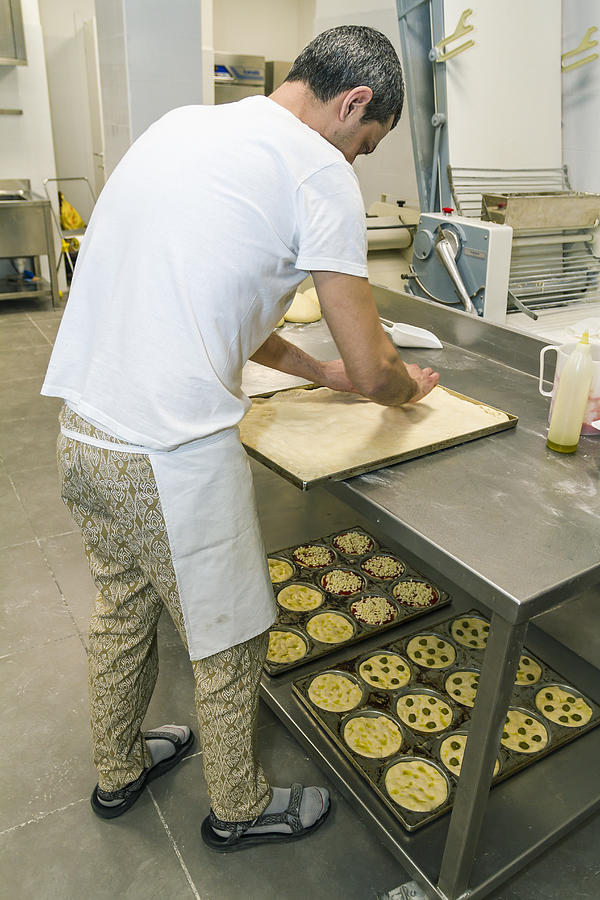 Baker preparing focaccia Photograph by PJPhoto69