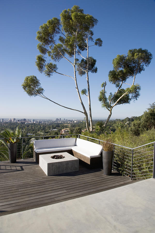 Balcony seating area overlooking cityscape Photograph by Tom Merton