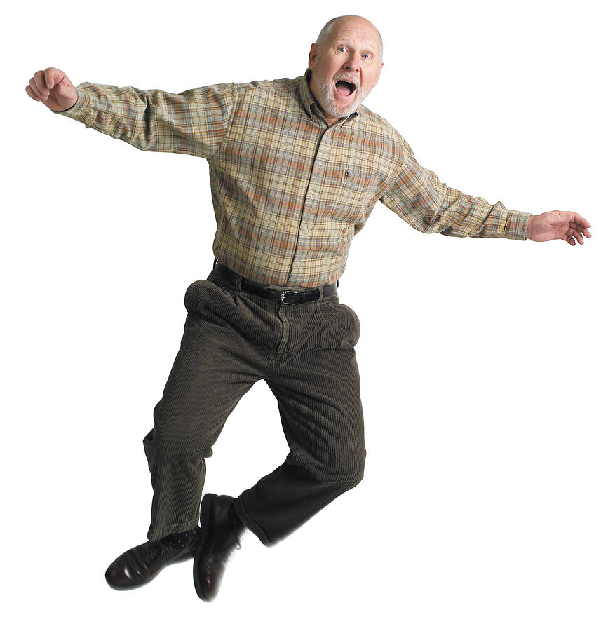 Balding elderly man jumps excitedly into the air. Photograph by Photodisc