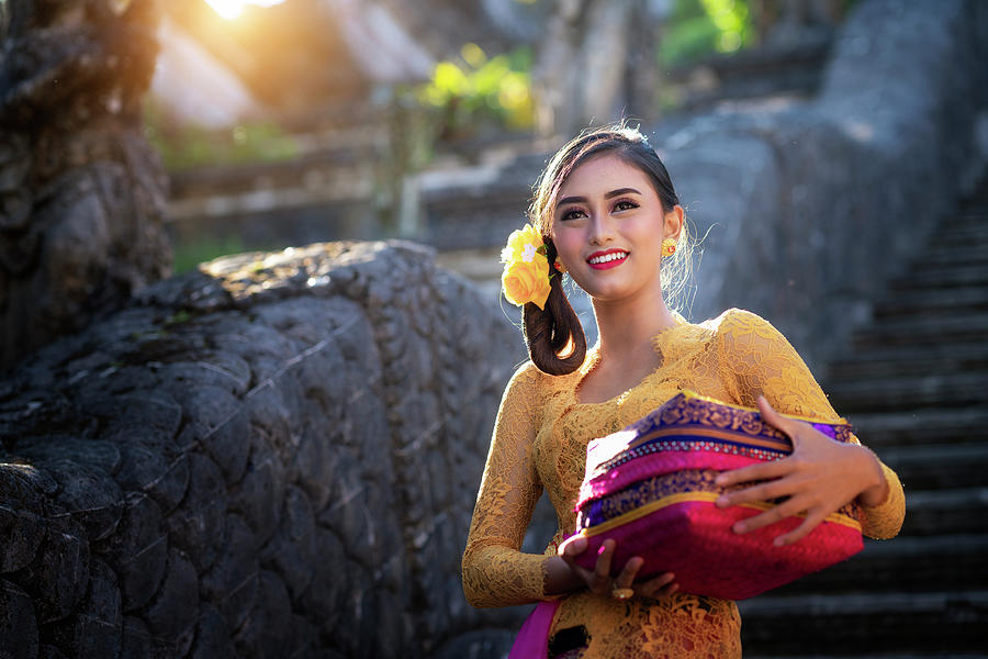 Bali Lady in Traditional dress walk in old temple Photograph by Anek Suwannaphoom