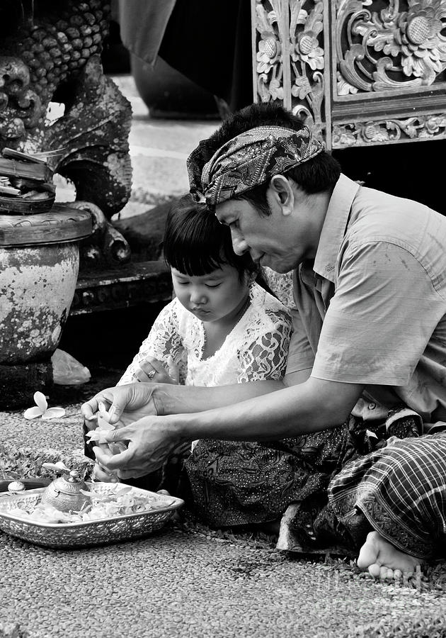 Balinese Father and Daughter making offerings Photograph by Craig Lovell