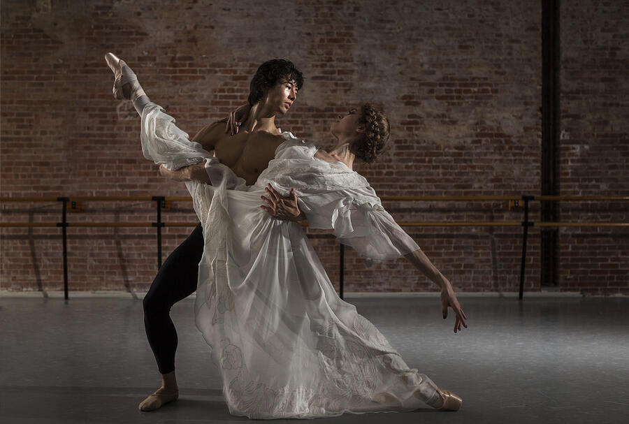 Ballerina and danseur performing partnering split Photograph by Nisian Hughes
