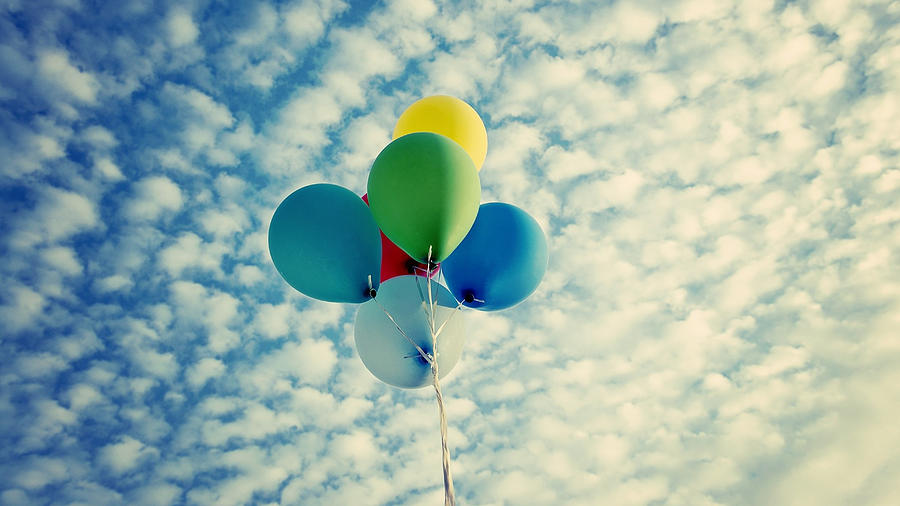 Balloons flying against cloud sky Photograph by beauty eyes / FOAP