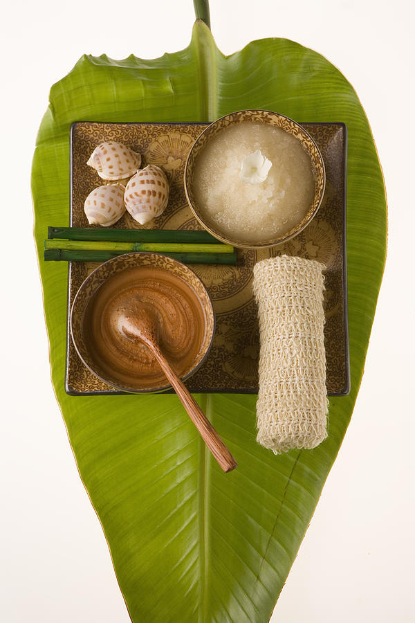 Banana leaf with ceramic bowls containing cosmetic items Photograph by Seth Joel