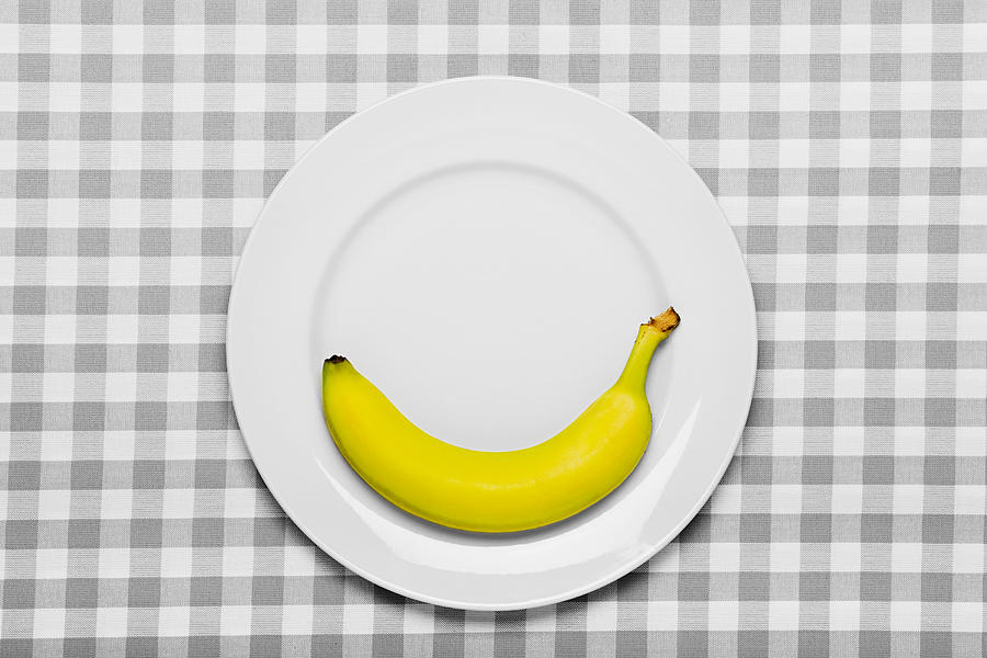 Banana on a plate Photograph by Image Source