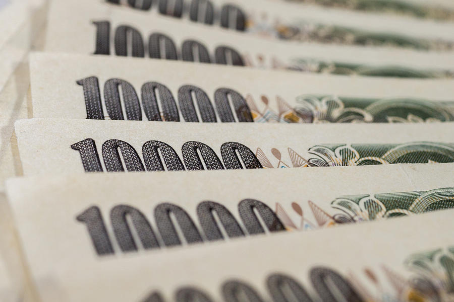 Banknotes of Japanese yen currency background Photograph by StockGood