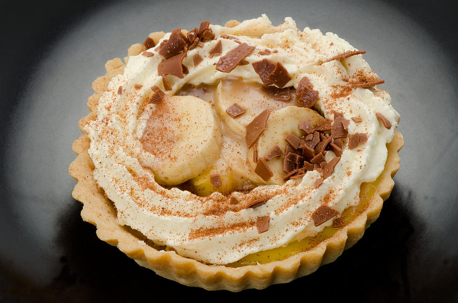 Banoffee pie on a black serving dish Photograph by Clubfoto