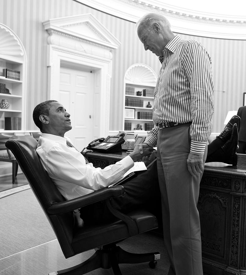 Barack Obama and Joe Biden shaking hands in the Oval Office - Pete Souza 2011  Photograph by War Is Hell Store