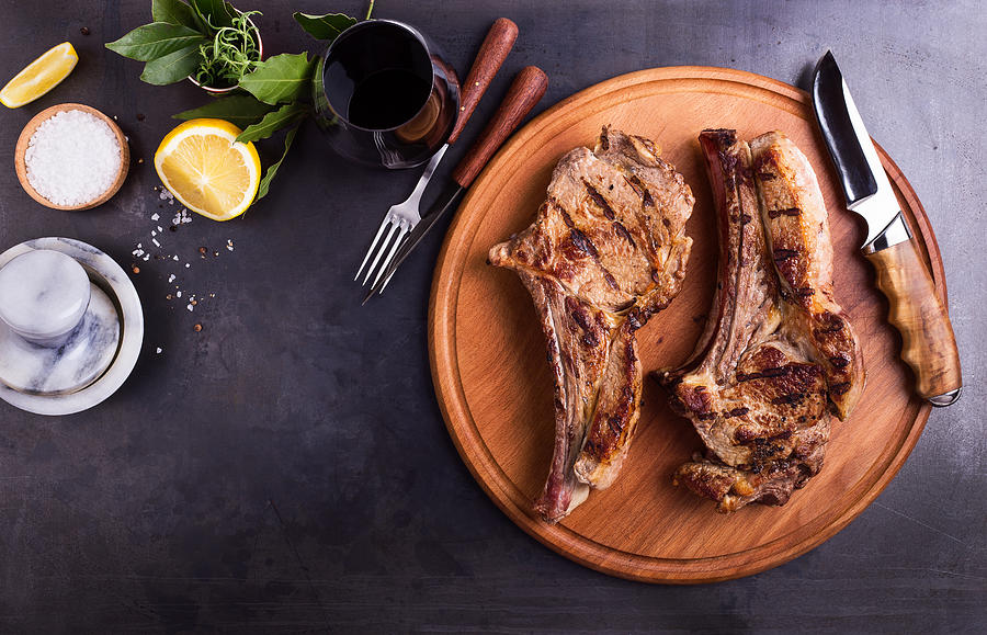 Barbecue bone-in ribeye steak on cutting board Photograph by Istetiana