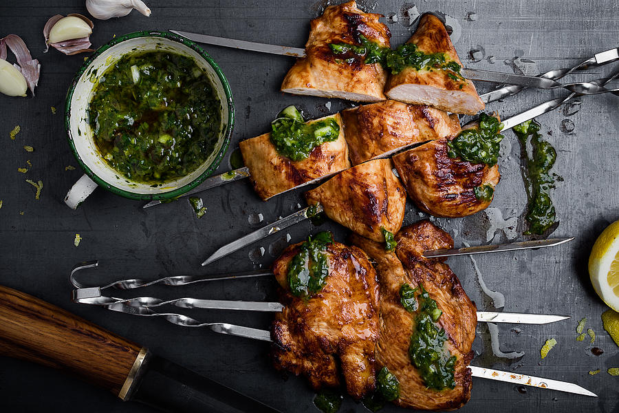 Barbequed chicken breast skewers with chimichurri sauce Photograph by Istetiana