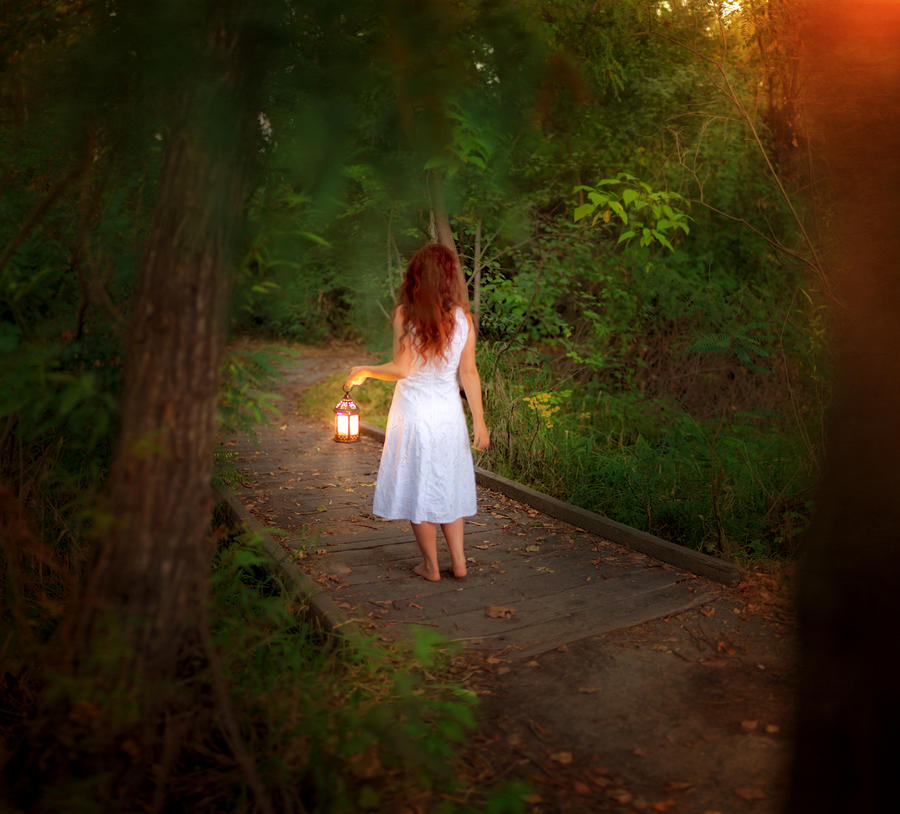 Barefoot girl in forest with lantern, rear view Photograph by Anna Gorin
