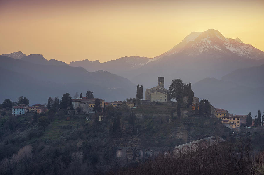 Barga town and Alpi Apuane mountains after sunset Photograph by Stefano Orazzini