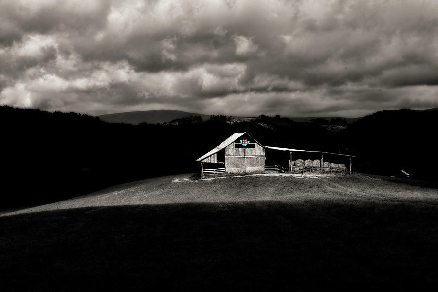 Barn out in the field with sunlight black and white Photograph by Dan Friend