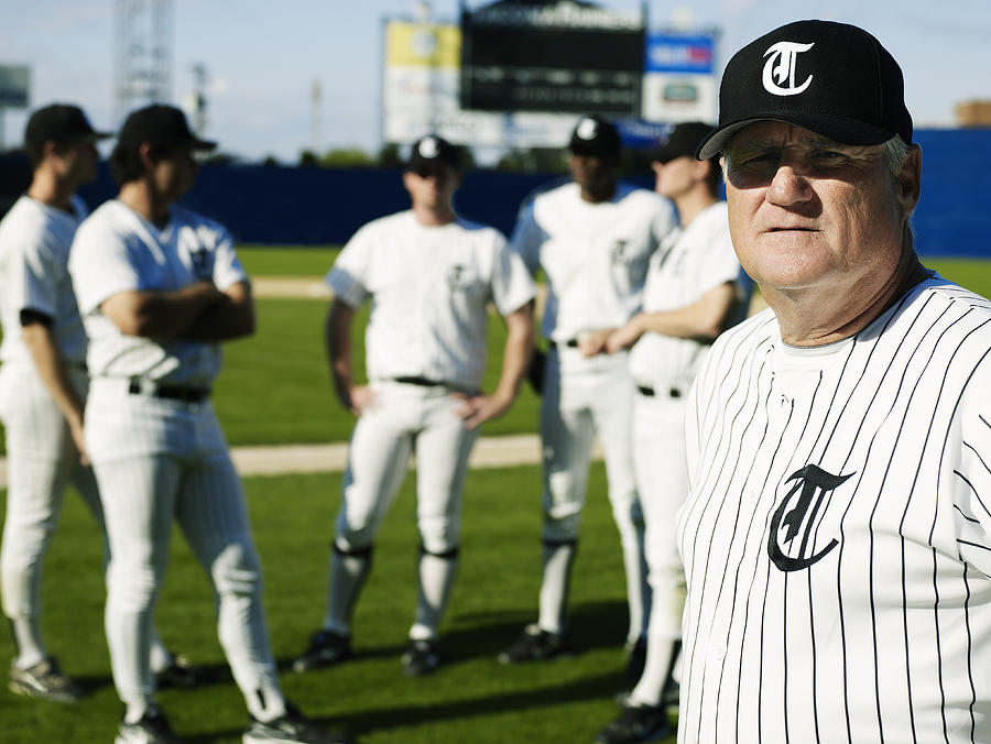 Baseball coach standing in front of players Photograph by Thomas Barwick