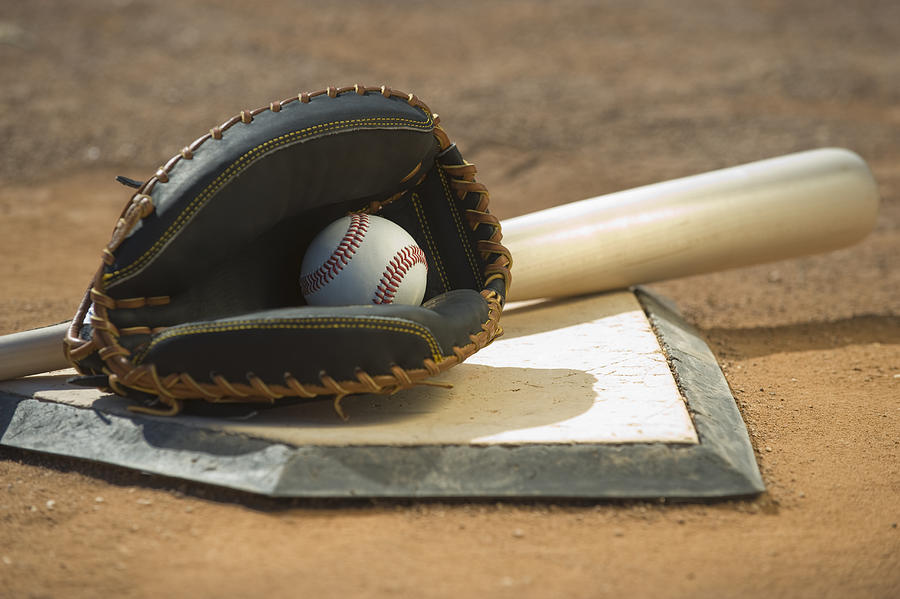 Baseball equipment on home plate Photograph by Tetra Images