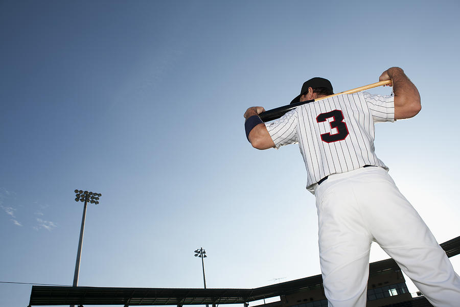 Baseball player holding bat, rear view Photograph by PhotoAlto/Sandro Di Carlo Darsa