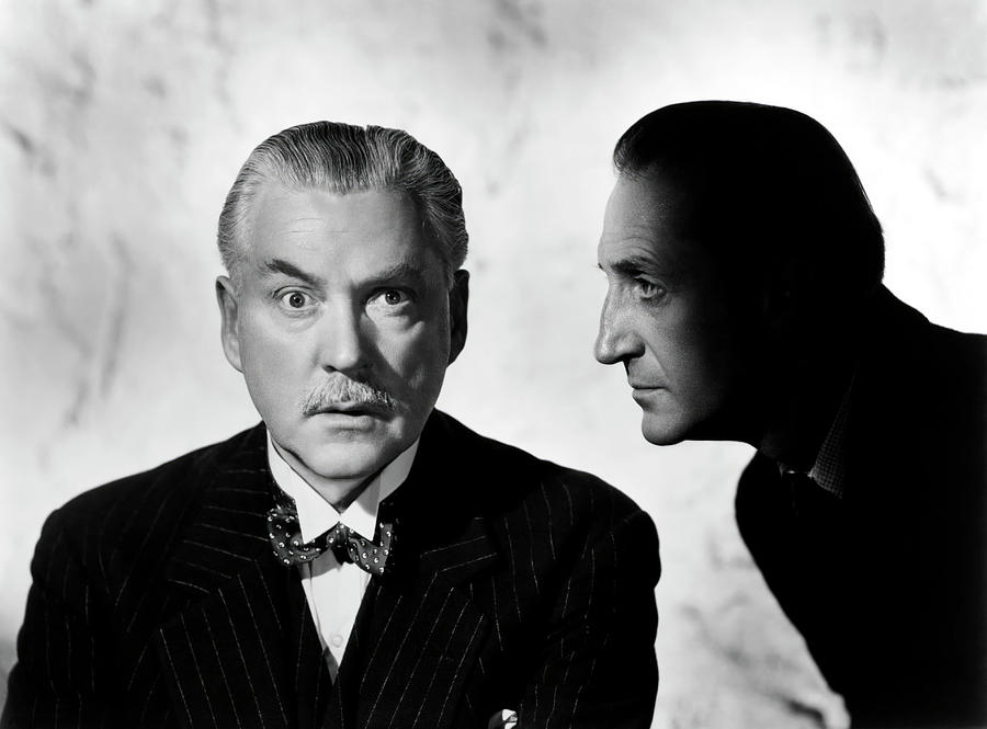 Sherlock Holmes Photograph - BASIL RATHBONE and NIGEL BRUCE in THE ADVENTURES OF SHERLOCK HOLMES -1939-. by Album