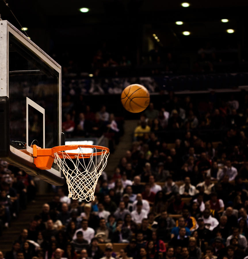 Basketball net with basketball near hoop Photograph by Jgareri