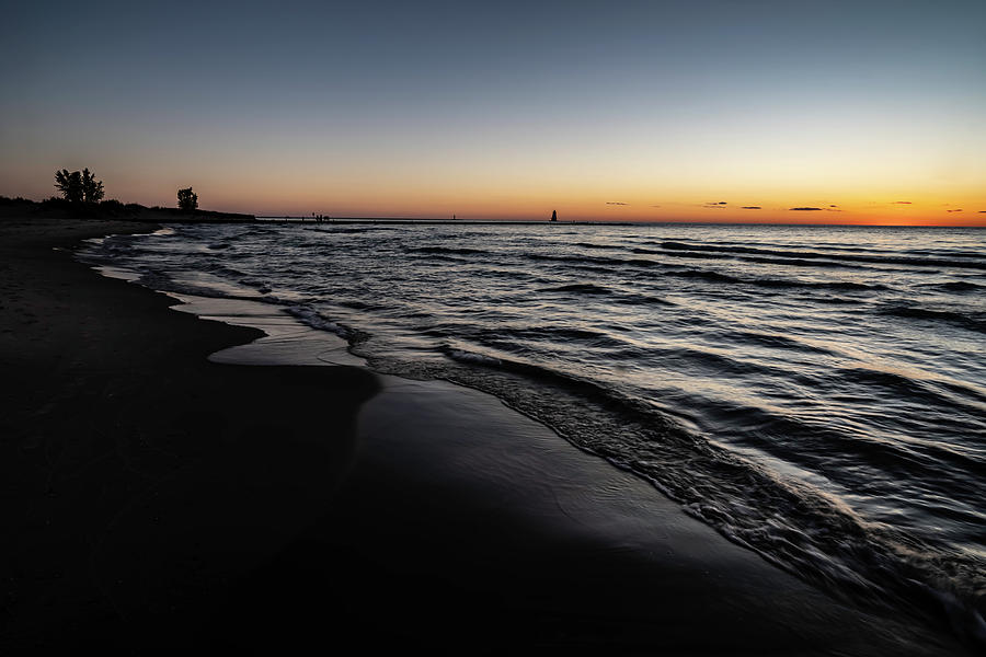 Beach and breakwater at dusk Photograph by Sven Brogren