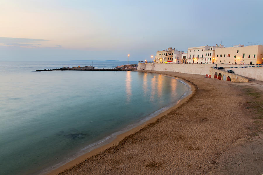 Beach and waterfront buildings at dusk, Lecce, Apulia, Italy Photograph by Alessandro Boschi