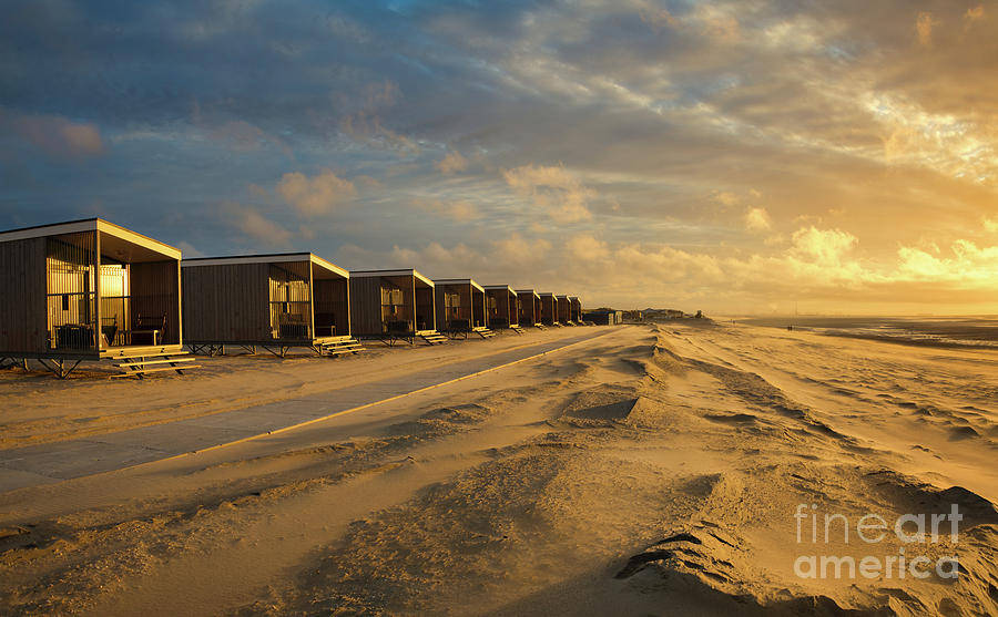 Sunset Photograph - Beach cabins in a row at the seaside at sunset by IPics Photography