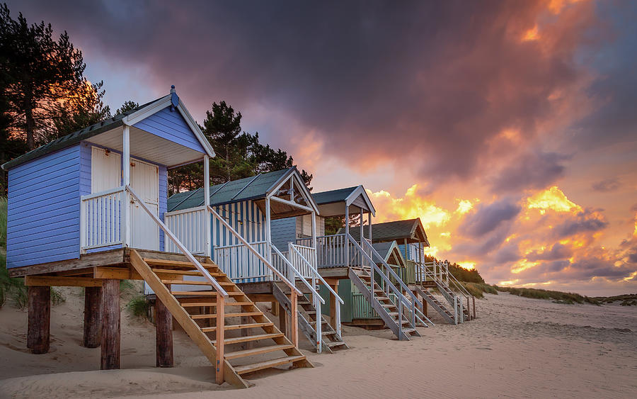 Sunset Photograph - Beach hut sunset at Well-next-the-sea by David Powley