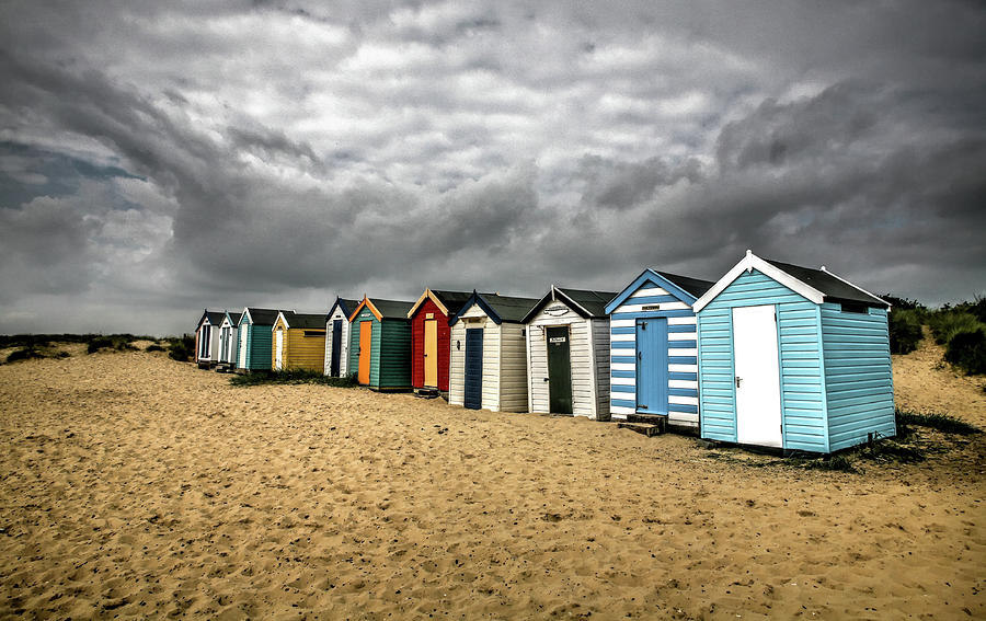 Beach huts at Southwold, England under a heavy sky. Photograph by Plus ...