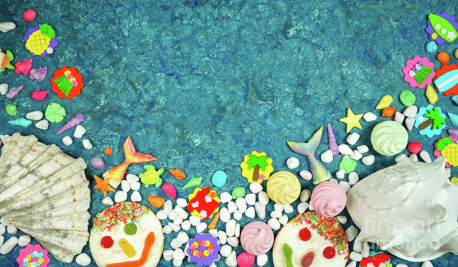Beach theme flatlay with shells, fish tails, summer party icons and cookies. Photograph by Milleflore Images