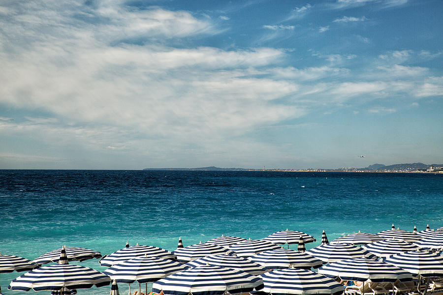 Beach Umbrellas on beach of the city of Nice Photograph by Jean-Marc PAYET