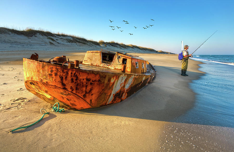 Beached Beauty and the Fisherman Photograph by Dan Carmichael