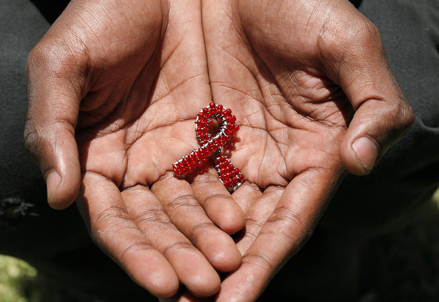 Beaded AIDS in hands Photograph by ManoAfrica