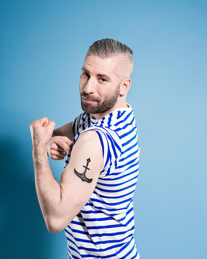 Bearded sailor man showing his anchor tatoo Photograph by Izusek