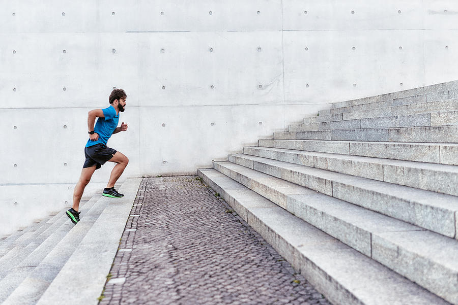 Bearded Sportsman Running Up Outdoor Stairway Photograph by Golero