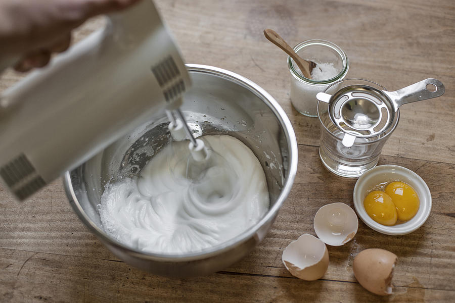 Beating egg white with electric whisk, elevated view Photograph by Westend61